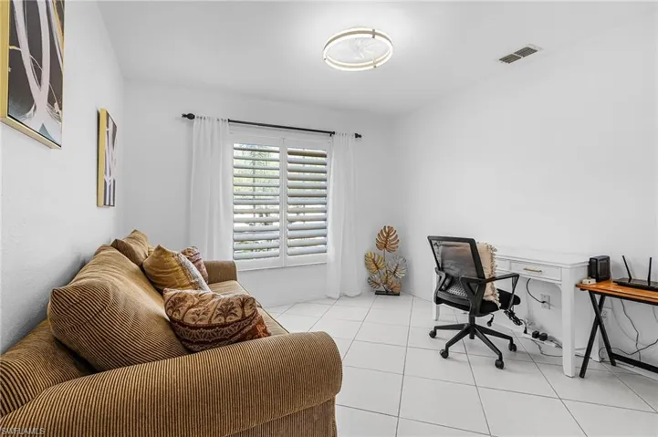 Office area featuring tile patterned flooring and baseboards