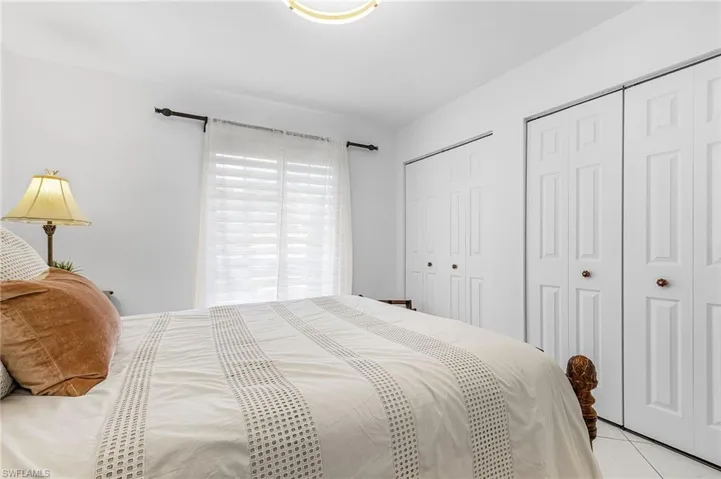 Bedroom featuring two closets and light tile patterned flooring