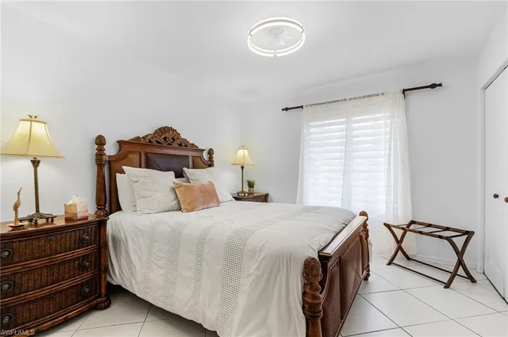 Bedroom with light tile patterned flooring