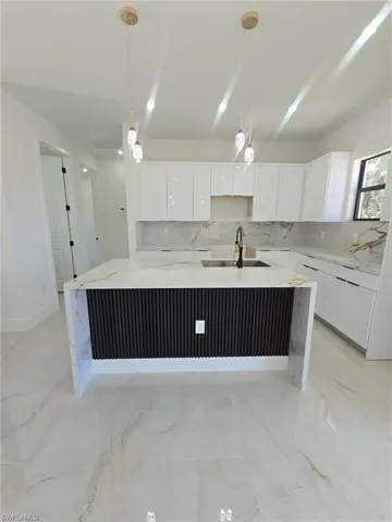 Unfurnished living room with recessed lighting, a ceiling fan, and light marble finish floors