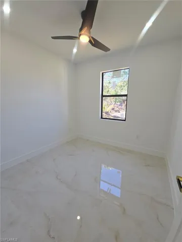 Garage featuring electric panel, a garage door opener, electric water heater, and a textured wall