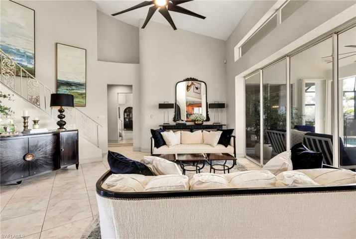 Living room with high vaulted ceiling and ceiling fan