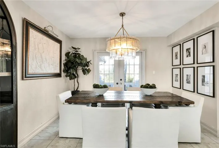 Dining area with french doors and a notable chandelier