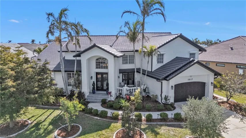 View of front of home with a garage and a front yard