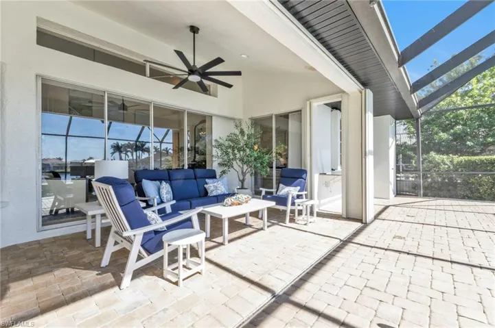 View of patio / terrace with an outdoor living space, a lanai, and ceiling fan