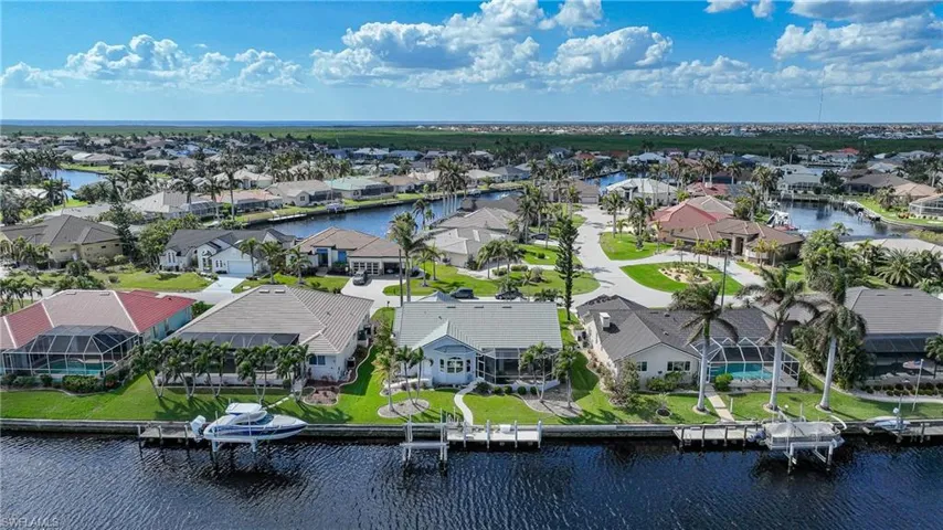 Birds eye view of property with a water view