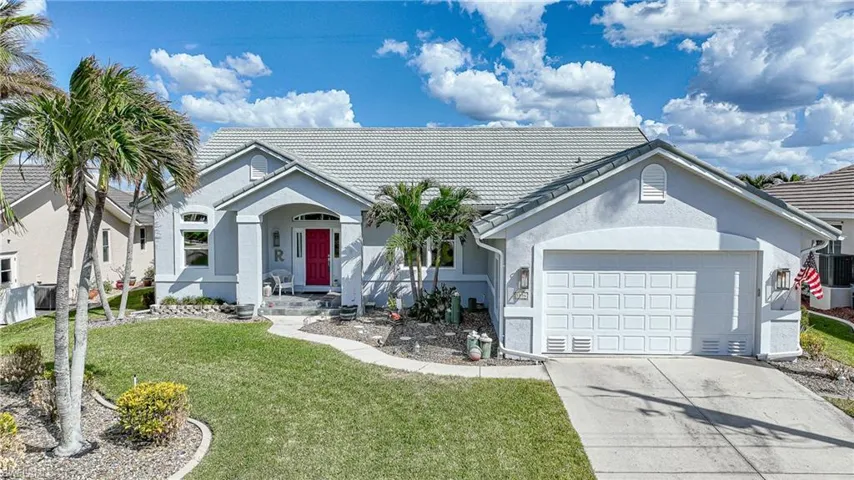 Ranch-style home with a yard and a garage