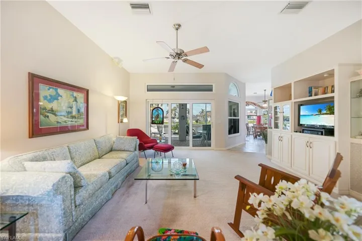 Living room featuring light carpet and ceiling fan