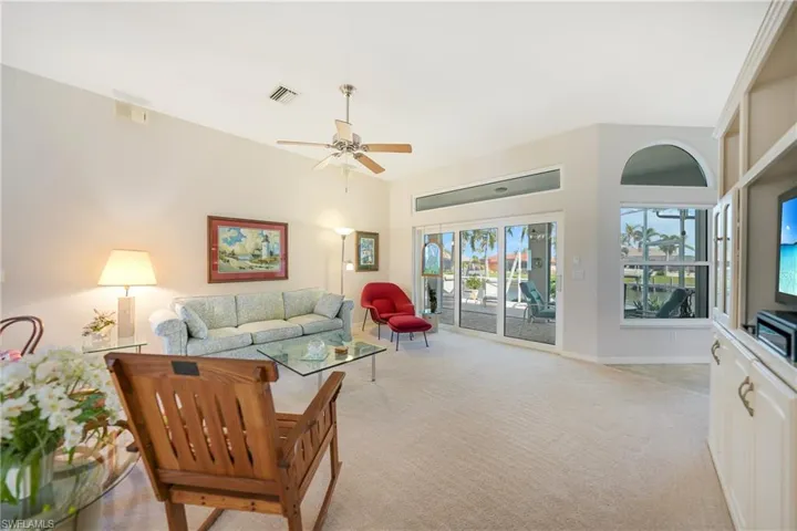 Living room featuring light carpet and ceiling fan