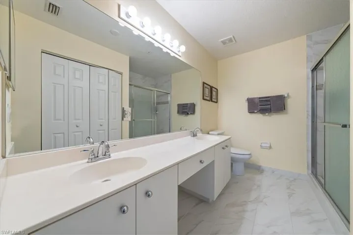 Bathroom featuring a sink, marble finish floor, and visible vents