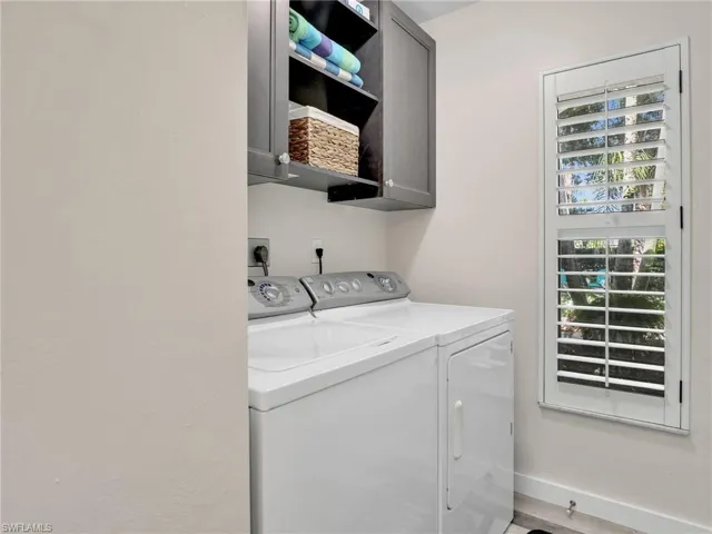 Laundry area offering cabinets for storage