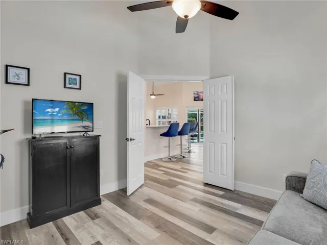Guest bedroom with double doors, luxury vinyl flooring and ample closet space