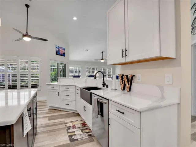 Kitchen with lofted ceiling offering a bright and open space