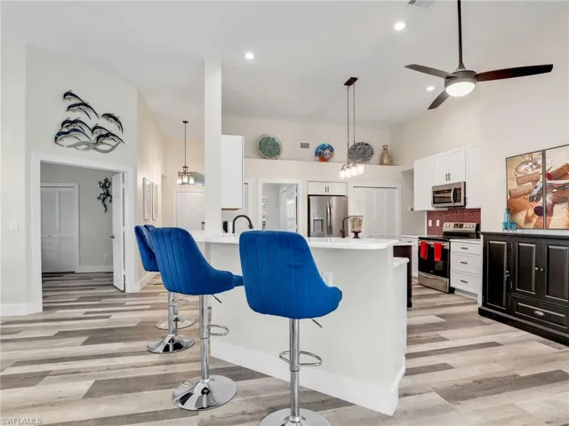 Kitchen featuring breakfast bar for ample seating