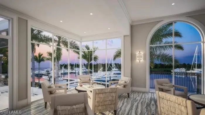 Sunroom featuring a water view