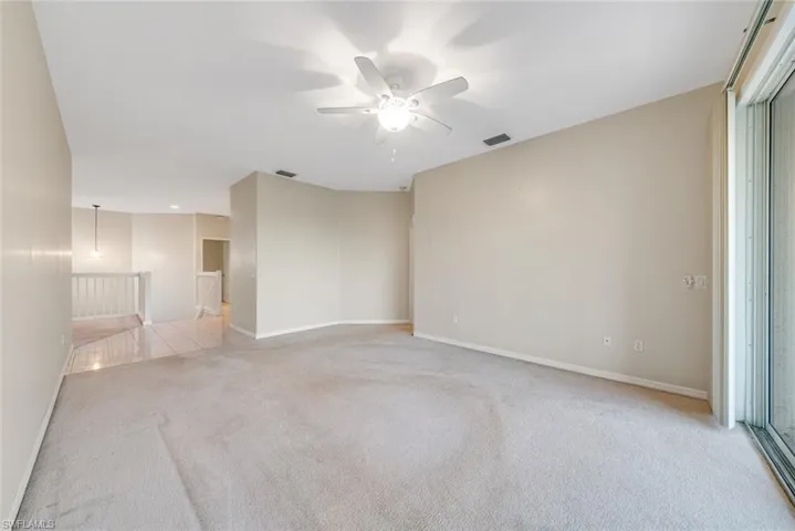 Spare room with light colored carpet and a ceiling fan