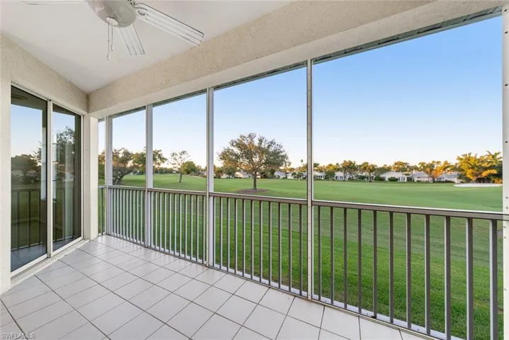 Unfurnished sunroom featuring golf course view and tile patterned flooring