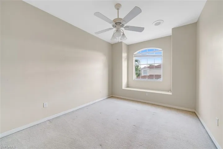 Spare room with carpet flooring and a ceiling fan