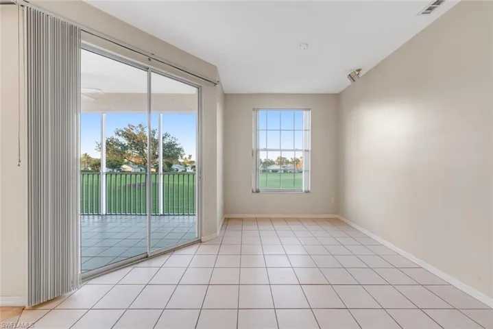 Empty room with light tile patterned floors