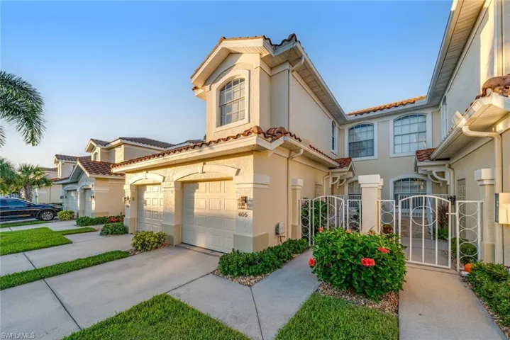 Mediterranean / spanish home featuring a gate, a garage, stucco siding, and driveway