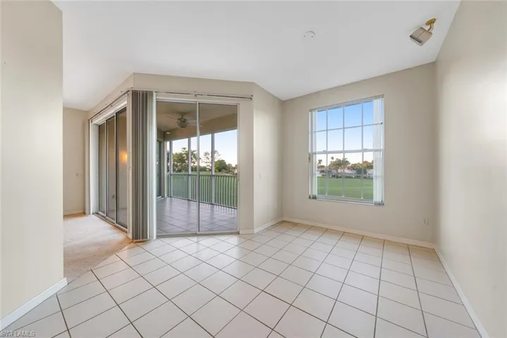 Empty room featuring baseboards and light tile patterned floors