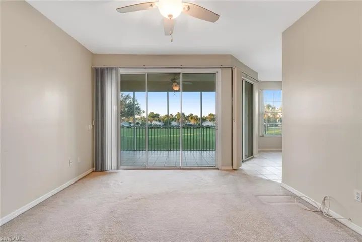 Carpeted spare room featuring baseboards