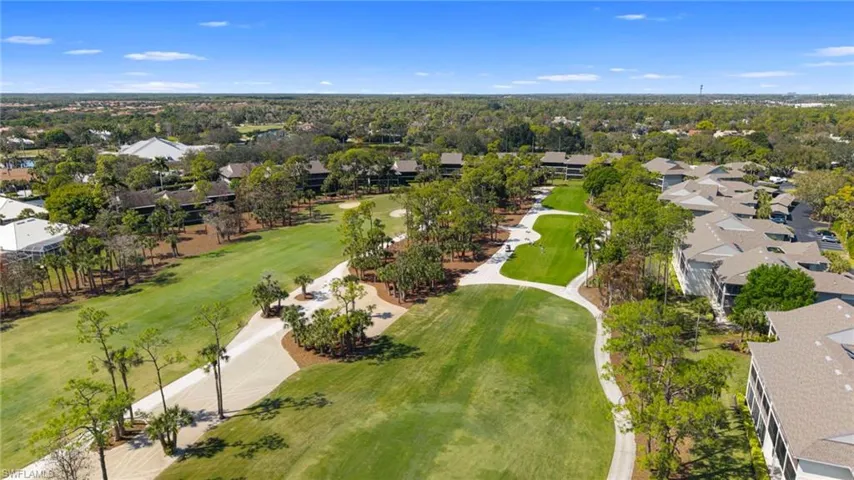 Aerial perspective of suburban area featuring a golf course