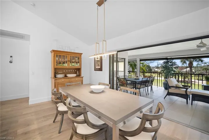 Dining space with lofted ceiling and light wood finished floors