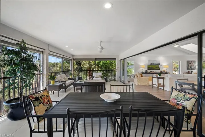 Sunroom featuring an outdoor living / dining area and ceiling fan