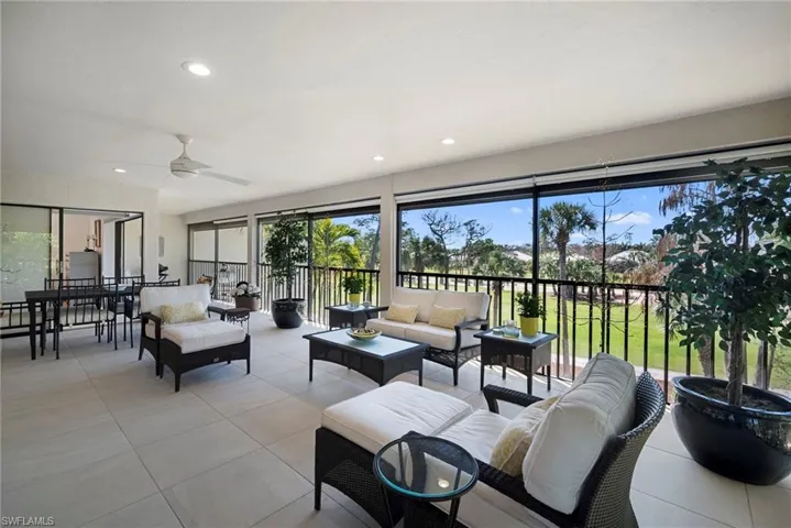 Sunroom featuring a ceiling fan and an outdoor living / dining area