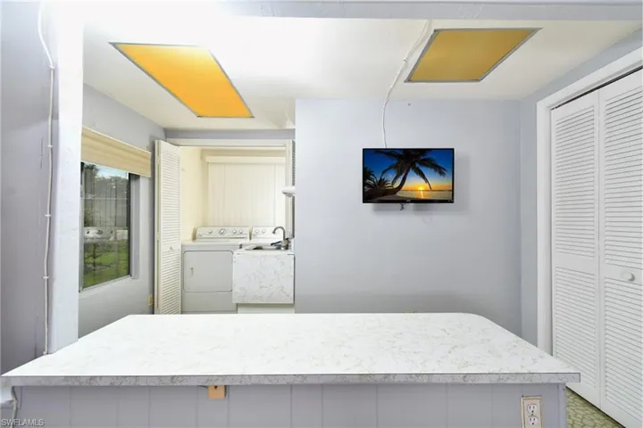 The spacious laundry room includes a utility sink