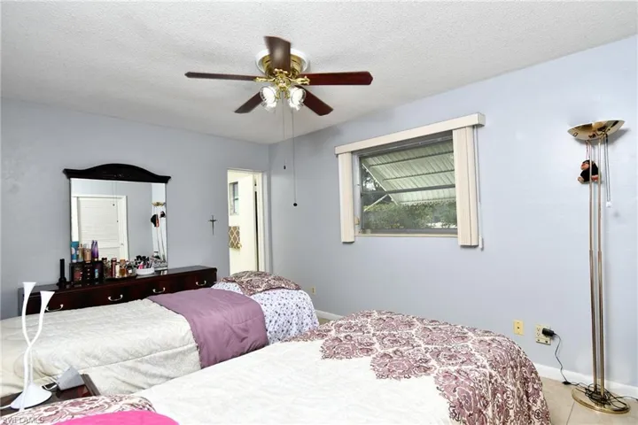 Interior space featuring light blue walls, a textured white ceiling, and light-toned tile flooring