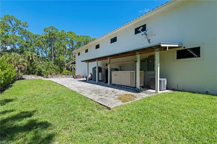 Rear view of Garage Building with Extra Covered Storage Area &  Whole House R.O Systems
