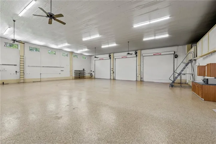 Additional View of 3600 sq. ft. (3) 13'x13 1/2' foot door garage with room for RVs, Boat & Trailer, (12) cars, featuring 15' High Corrugated Steel Ceiling & ceiling fan, Full RV Hook-up, workbench w/ sink.