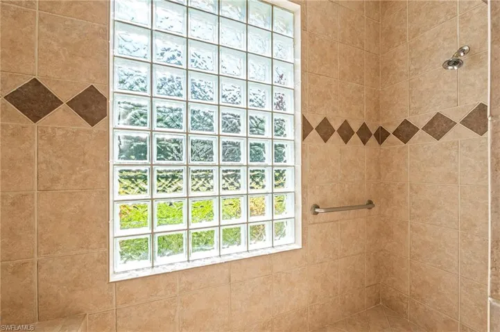 Primary Bathroom featuring a Walk-in Shower w/ Glass Block Window