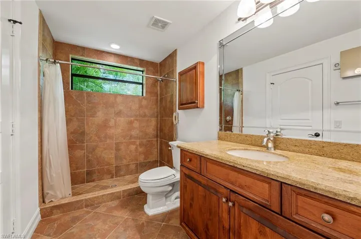 Guest Quarters Full Bathroom with tile tub/shower