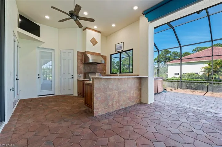 Outdoor Kitchen featuring Built-in Gas Grille and Bar w/ AC Storage Closet