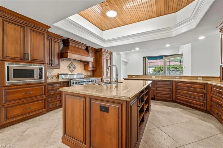 Chef's Kitchen top of the line stainless steel, custom exhaust hood, and center island