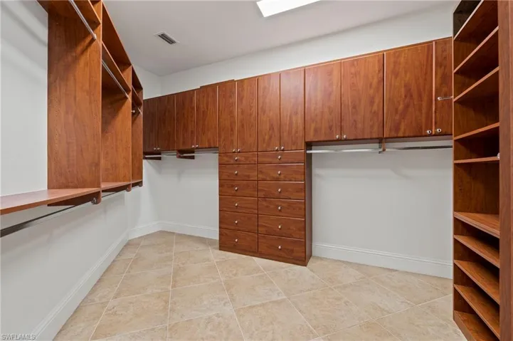 Spacious Primary Bedroom closet w/ Custom Wood Closet Built-in Cabinet System