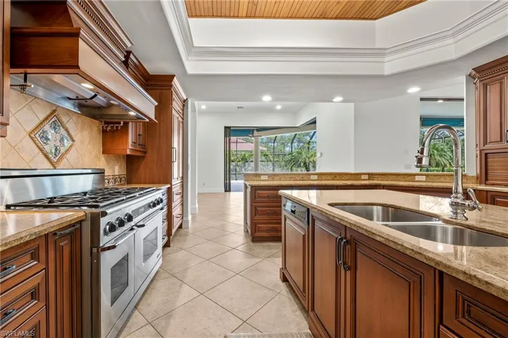Chef's Kitchen top of the line stainless steel appliances, decorative backsplash, and a wealth of natural light