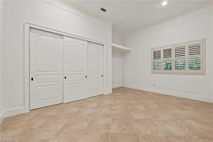 Guest bedroom #2 with large closet, crown molding & Plantation Shutters