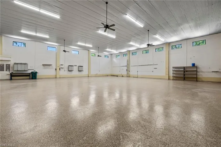 3600 sq. ft. (3) 13'x13 1/2' foot door garage with room for RVs, Boat & Trailer, (12) cars, featuring 15' High Corrugated Steel Ceiling & ceiling fan, Full RV Hook-up, workbench w/ sink.