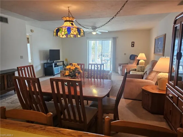 Dining room with a ceiling fan and a textured ceiling
