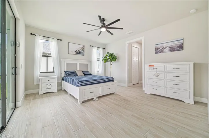Bedroom featuring ceiling fan and light hardwood / wood-style flooring