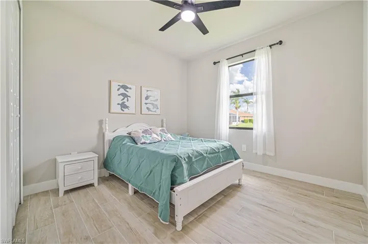 Bedroom featuring light wood-type flooring and ceiling fan