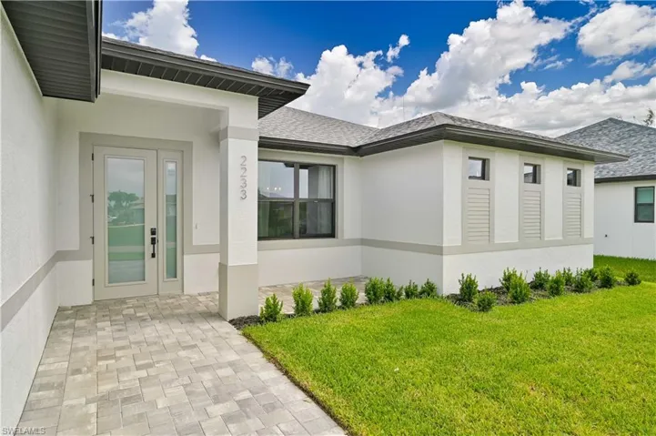 Property entrance featuring a lawn