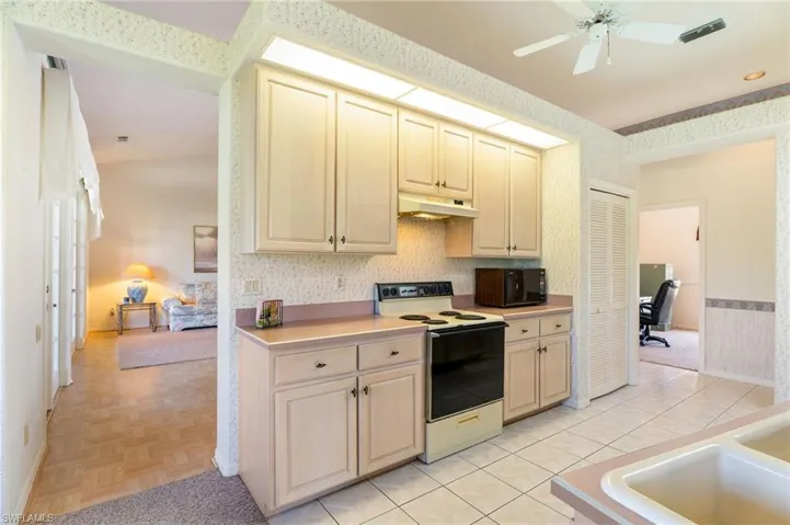 Dining space featuring french doors, decorative columns, a ceiling fan, and healthy amount of natural light