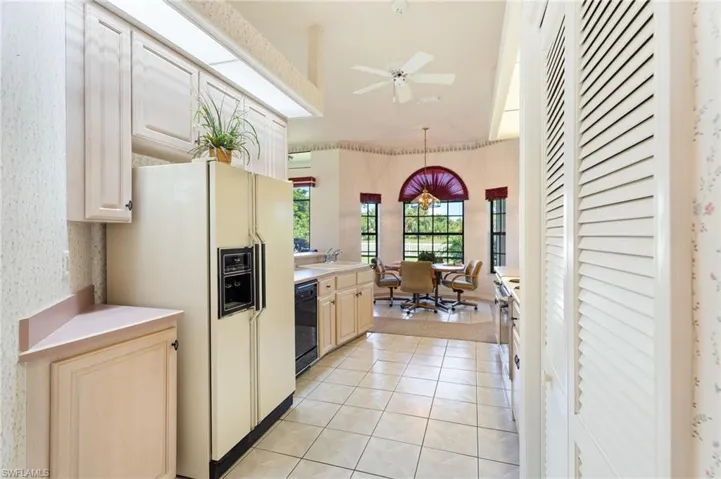 Entryway with wallpapered walls, healthy amount of natural light, tile patterned floors, and french doors