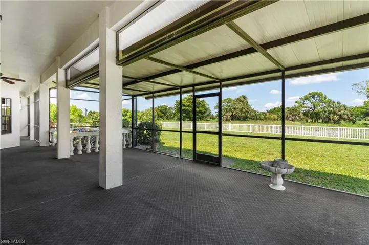 Carpeted bedroom featuring access to outside and baseboards