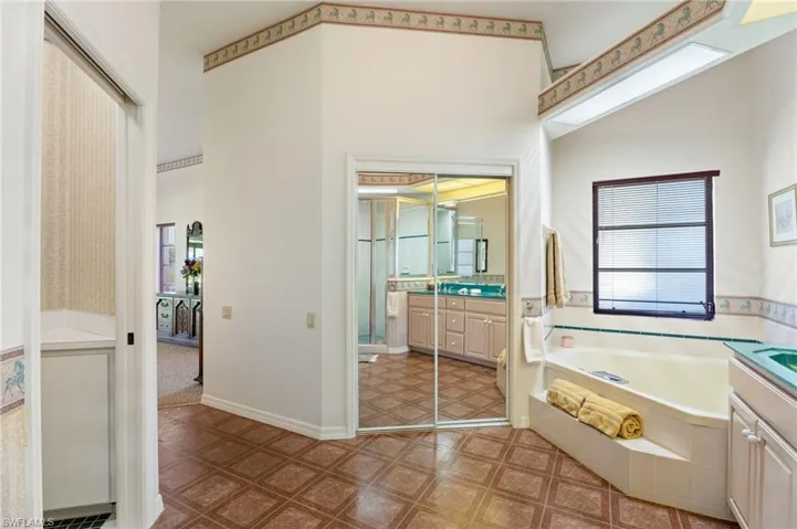 Carpeted living area featuring plenty of natural light and a ceiling fan